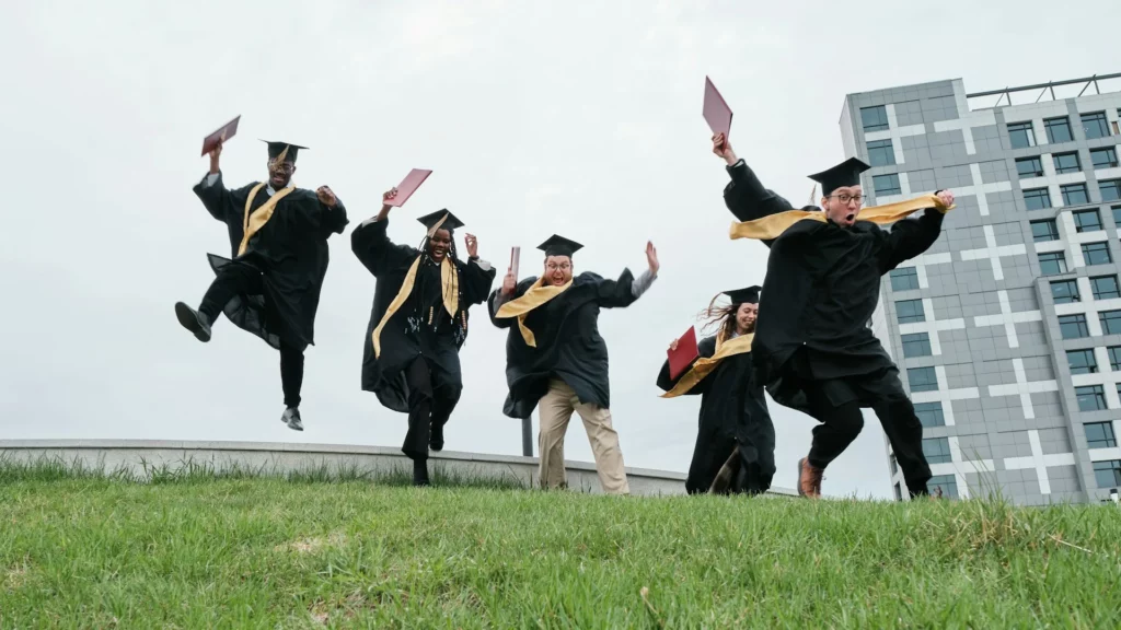 photo - five nursing grads throwing hats and wondering can a new grad nurse be a travel nurse