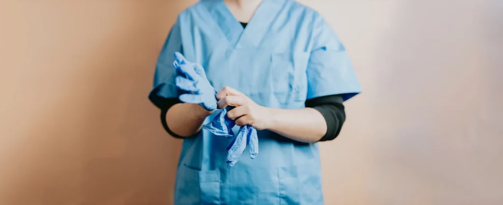 nurse putting on gloves
