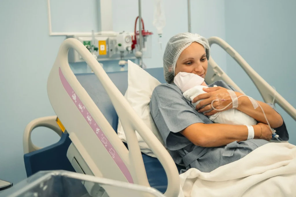 photo - a woman holding her newbord after her labor