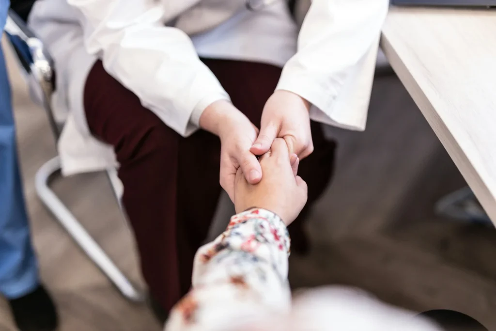 photo - a nurse holding her patient's hand at one of the best rural hospitals in texas
