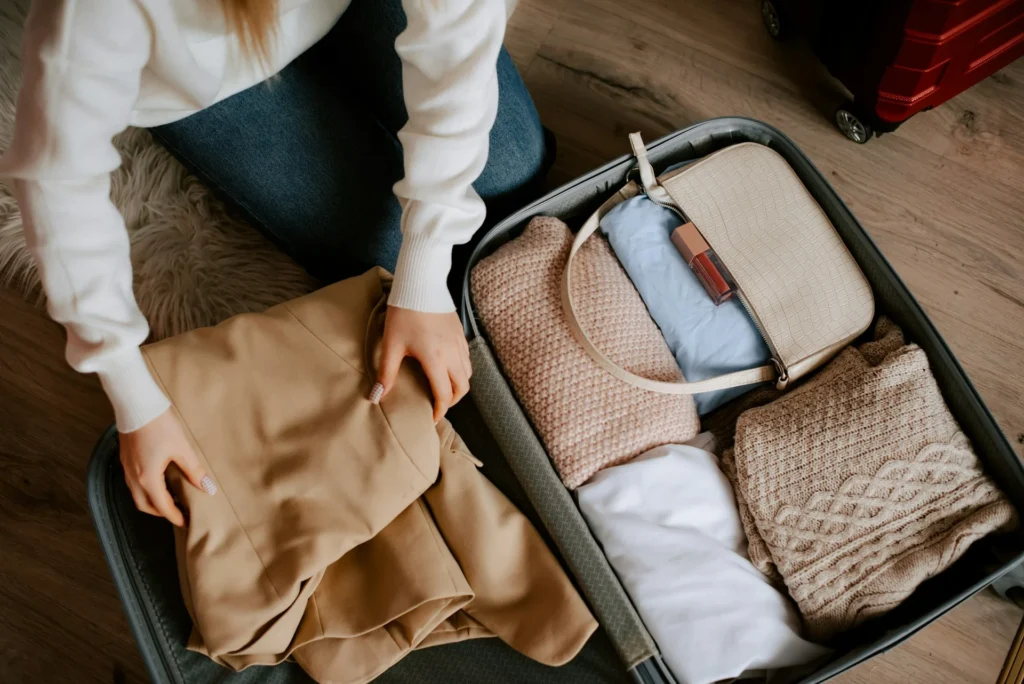 photo - a woman packing to fly to her travel nursing housing